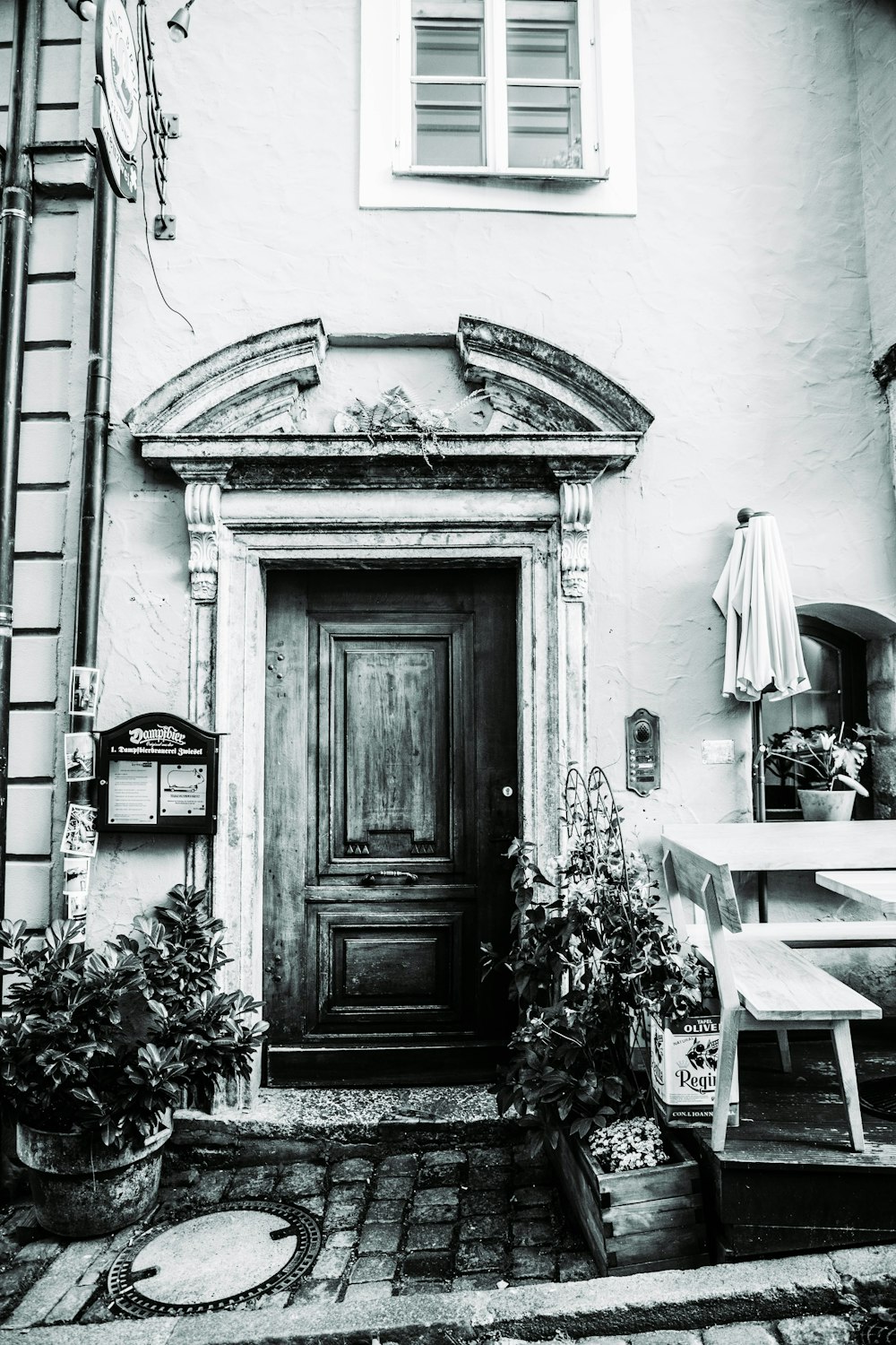 a black and white photo of a door and steps