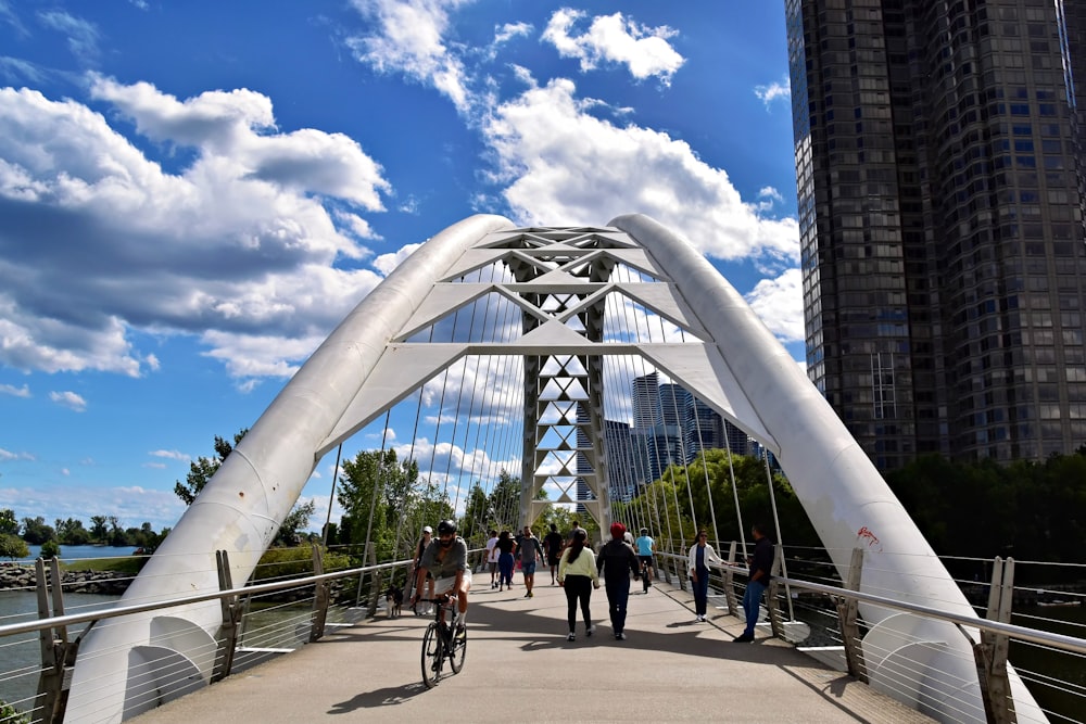 a group of people riding bikes across a bridge