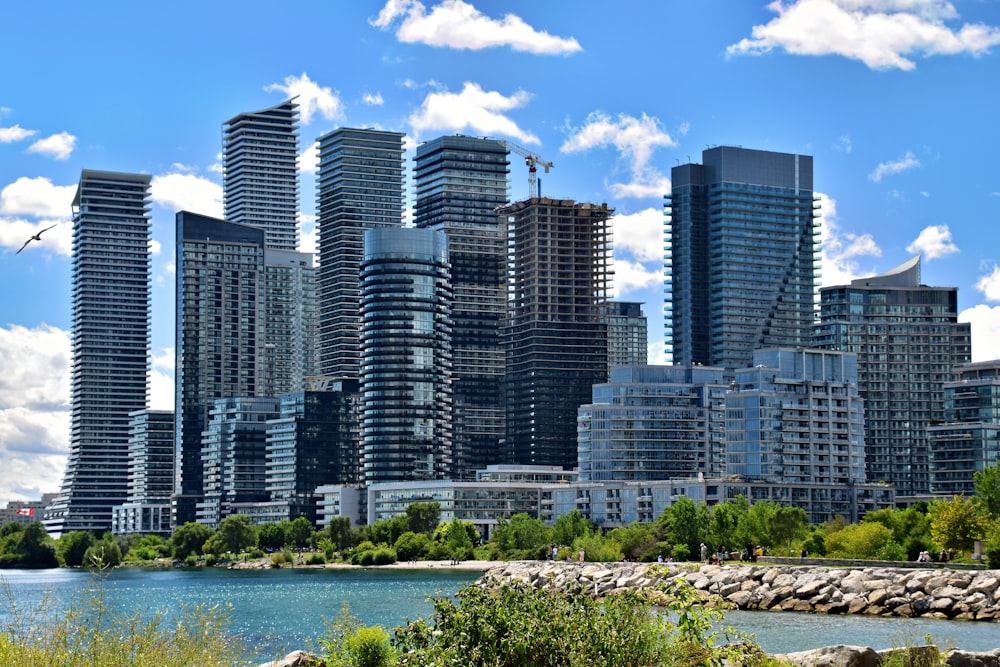 a group of tall buildings next to a body of water