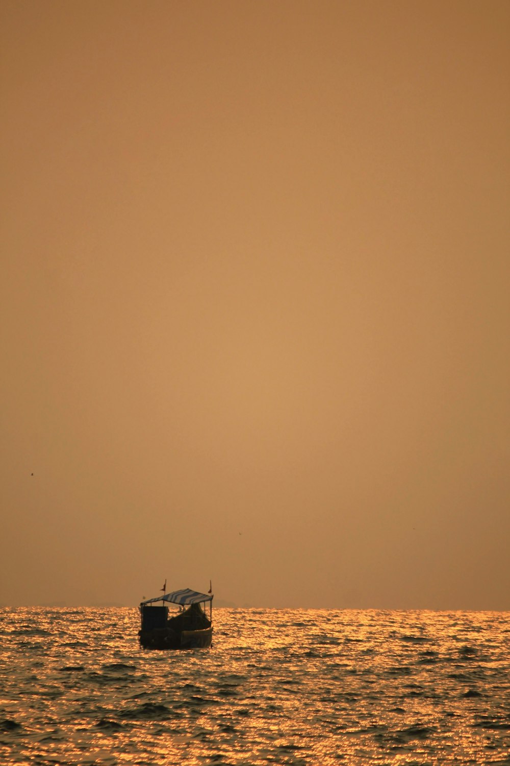 a small boat floating on top of a large body of water