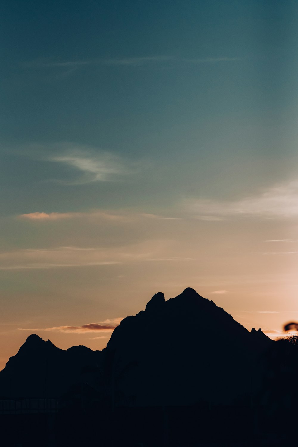 a plane flying over a mountain at sunset