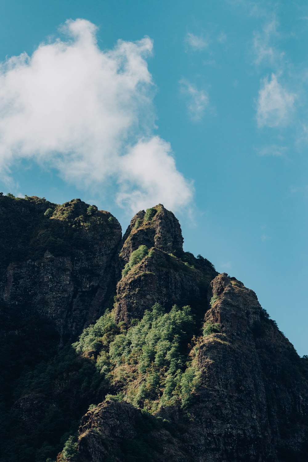 a very tall mountain with a sky in the background