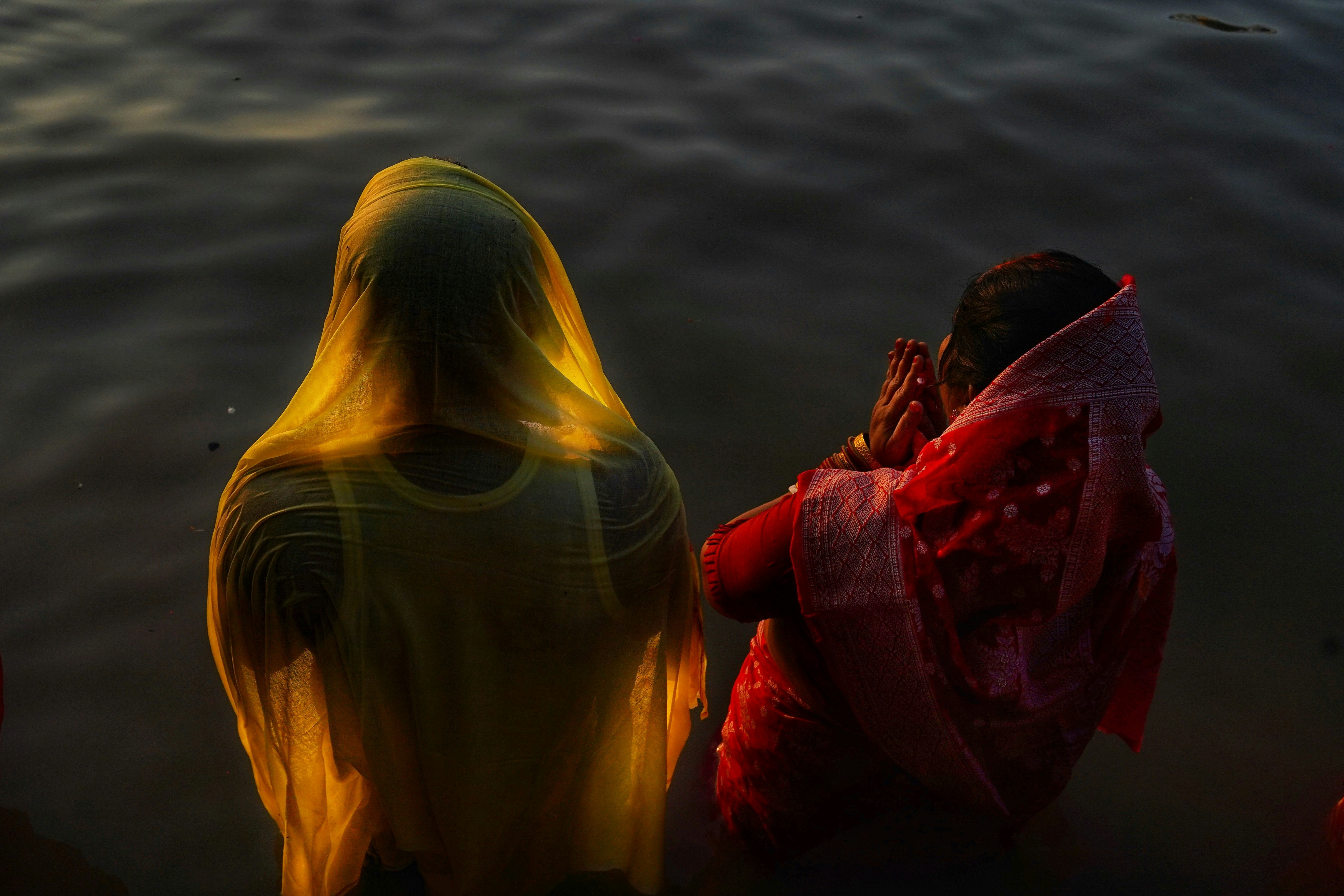 Woman in sari standing in water