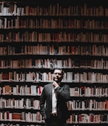 A thoughtful manager sitting at a desk, looking reflective with leadership books nearby.