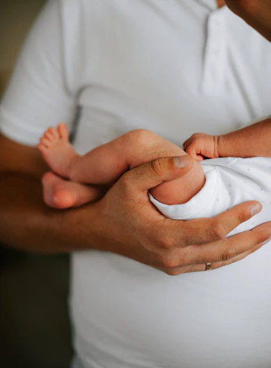 a man holding a baby in his arms
