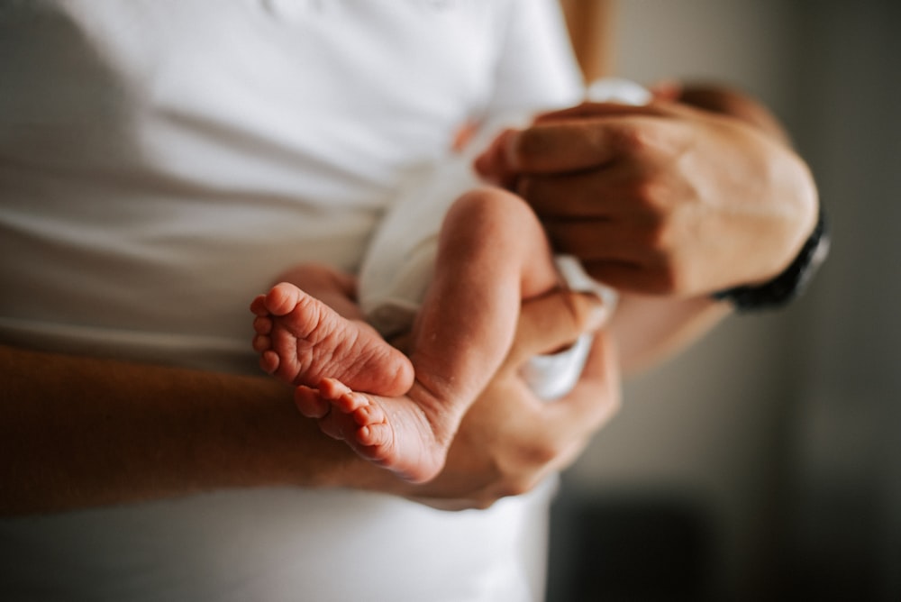 a person holding a baby in their arms