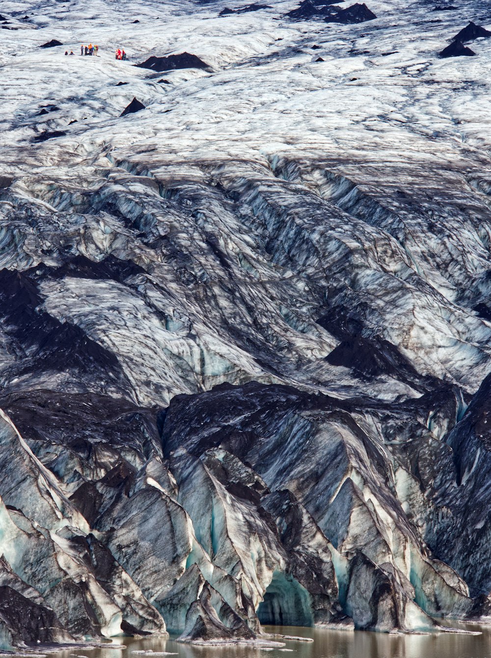 a group of mountains that are next to a body of water