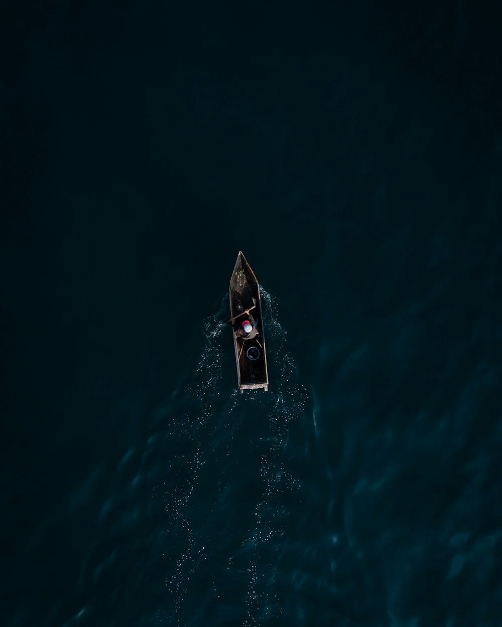 a small boat floating on top of a body of water