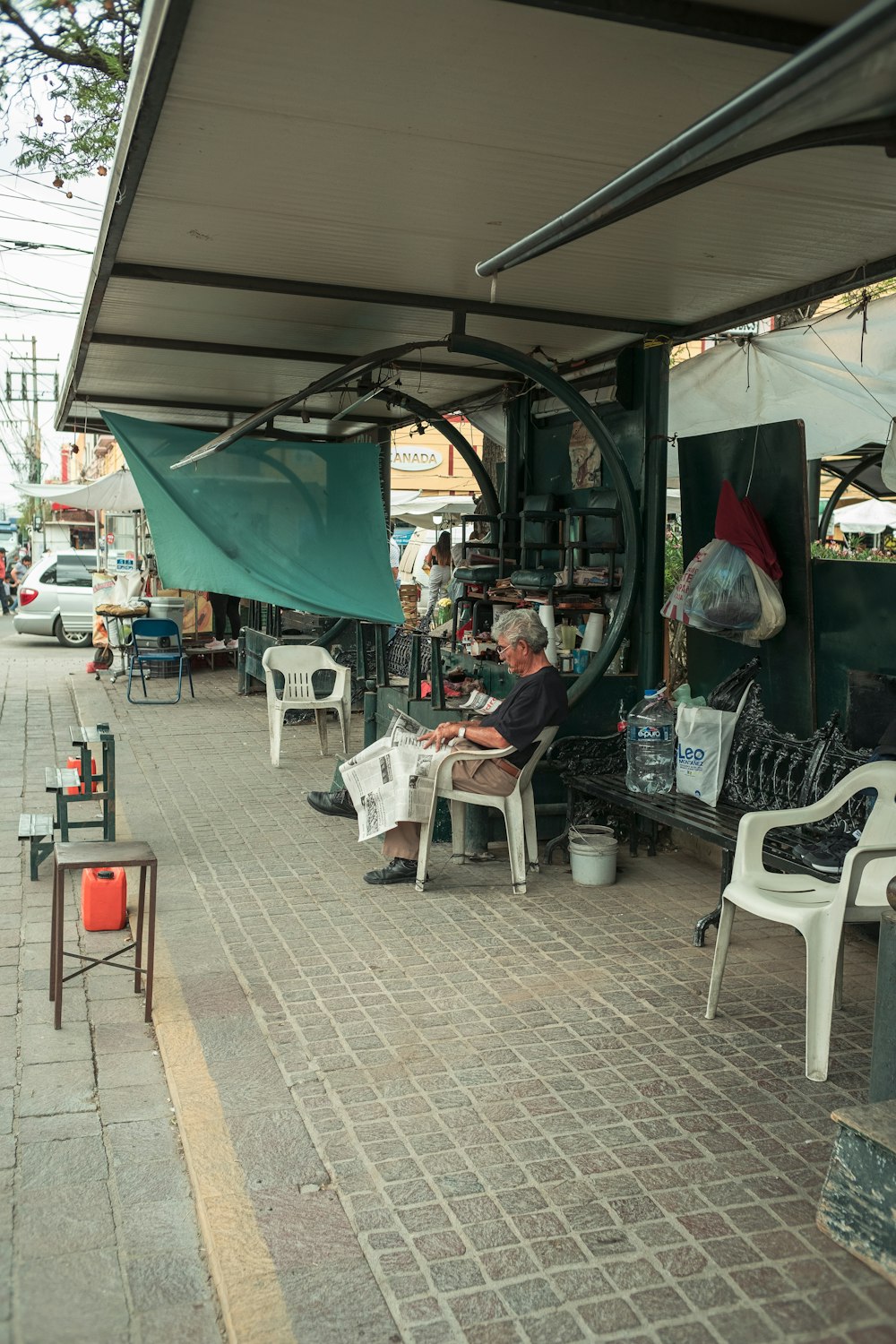 a man sitting on a bench under a canopy