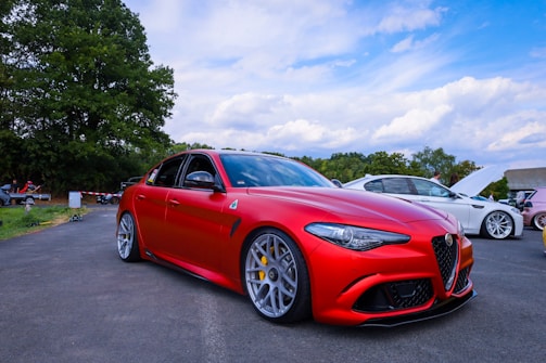 Vibrant red sports car wrapped with hentair’s high-gloss film on a sunny day.
