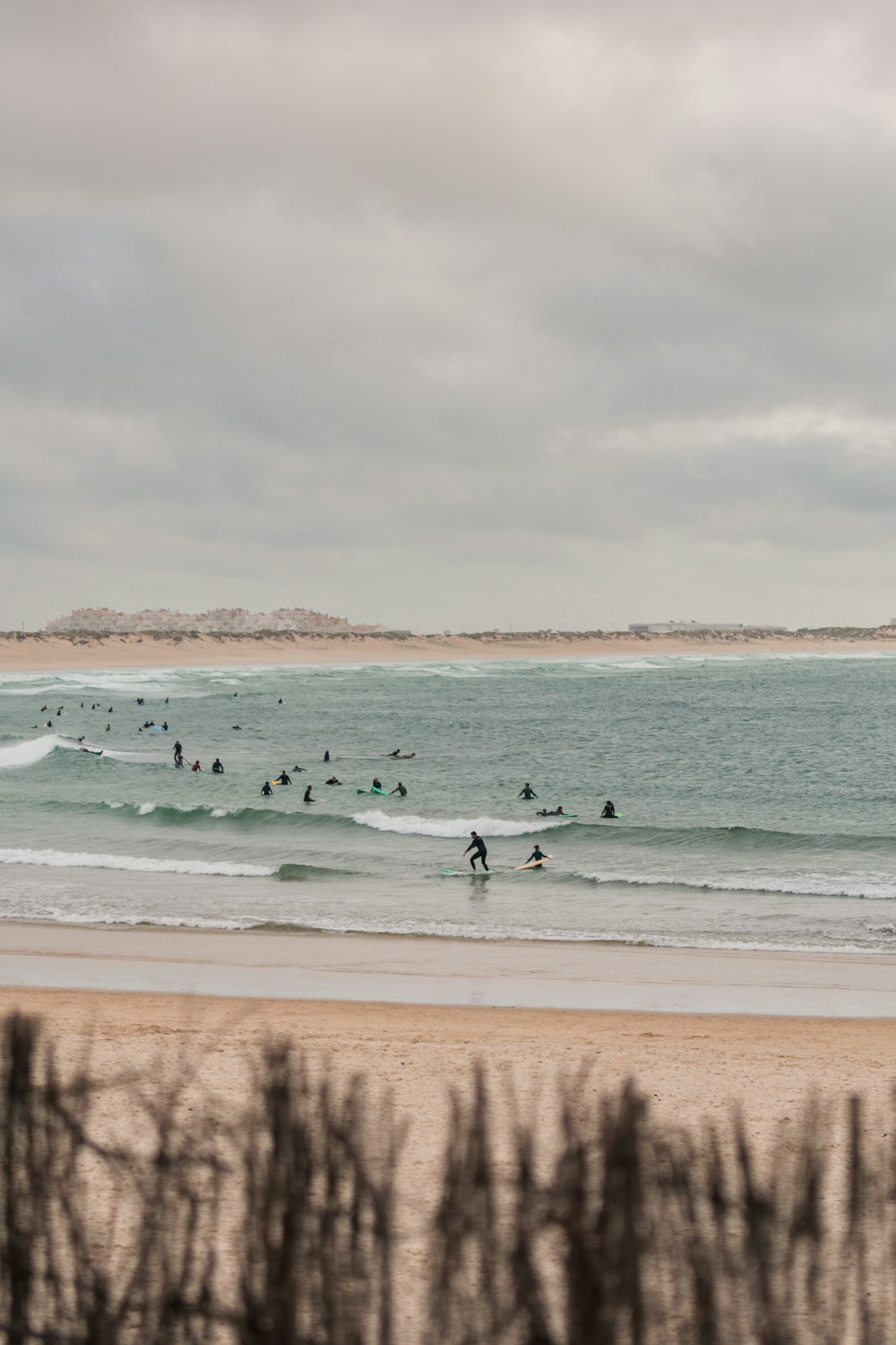 a group of people riding surfboards on top of a wave