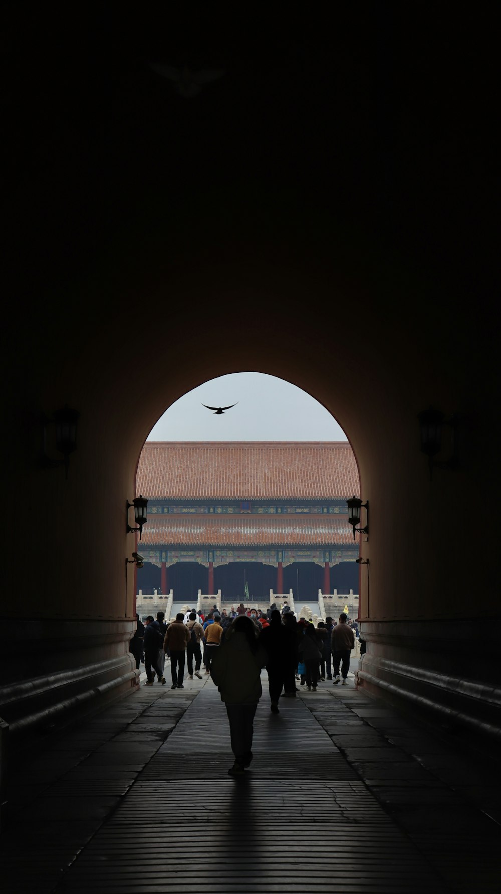 a group of people walking through a tunnel