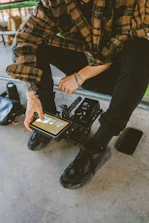 A service engineer troubleshooting equipment with a tablet in hand.