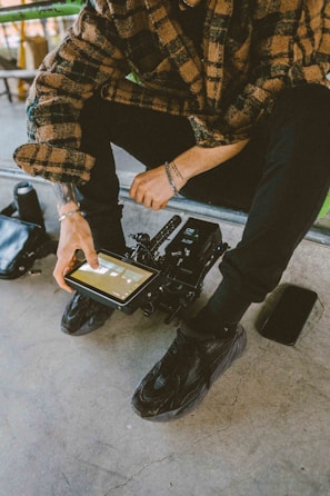 Technician reviewing system integration plans on a tablet surrounded by hardware.