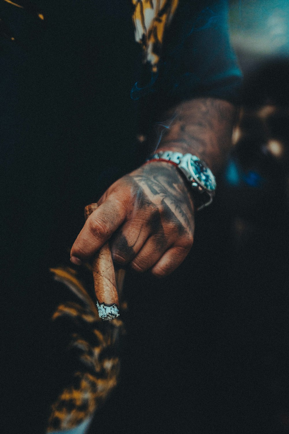 a close up of a person's hand with a ring on it