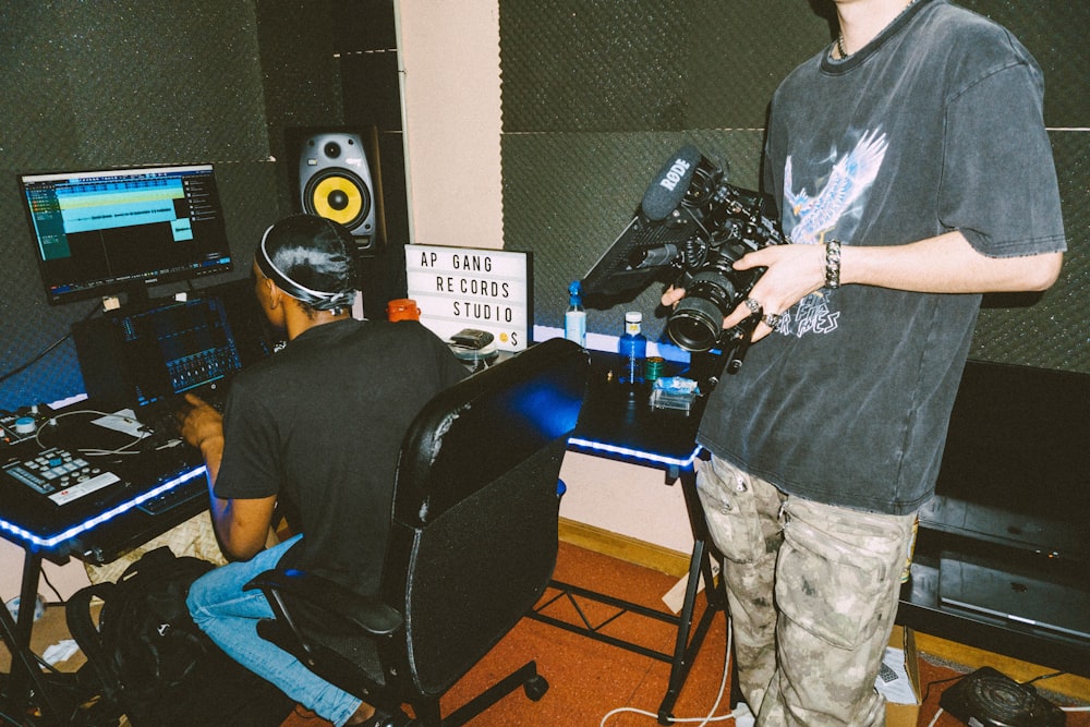 a couple of men standing in front of a sound board