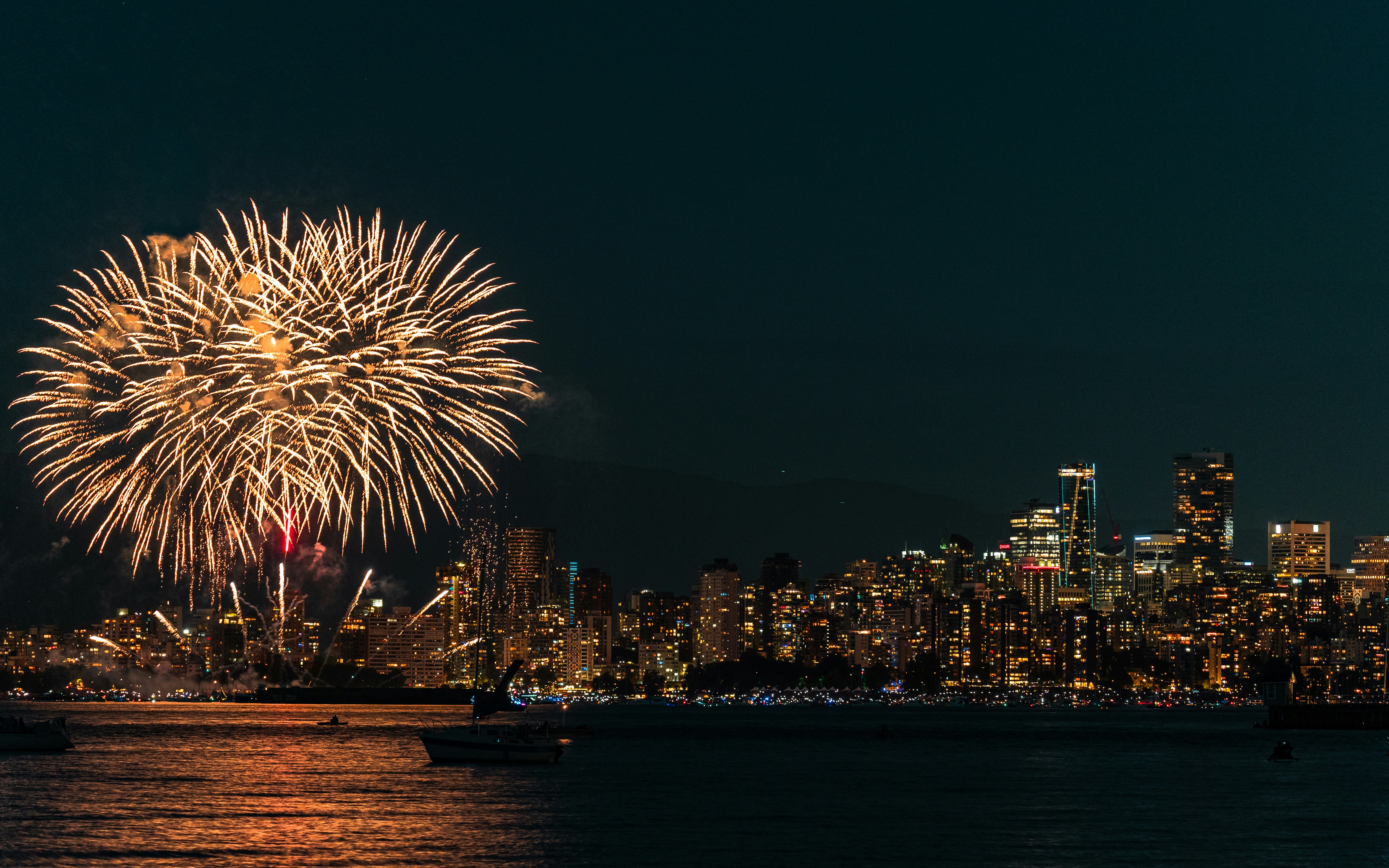 A fireworks display over a city skyline at night photo Free Canada