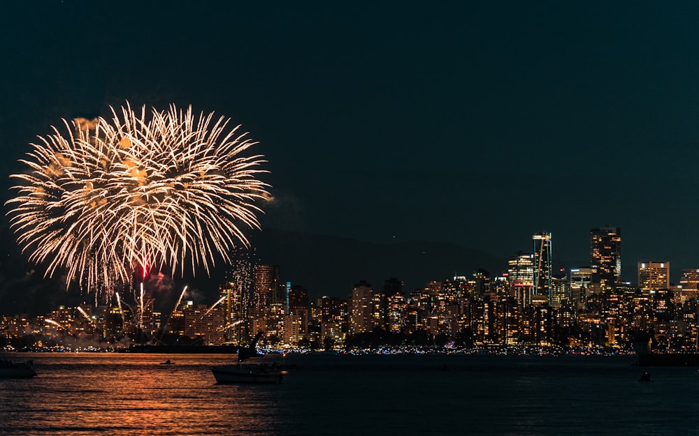 a fireworks display over a city skyline at night