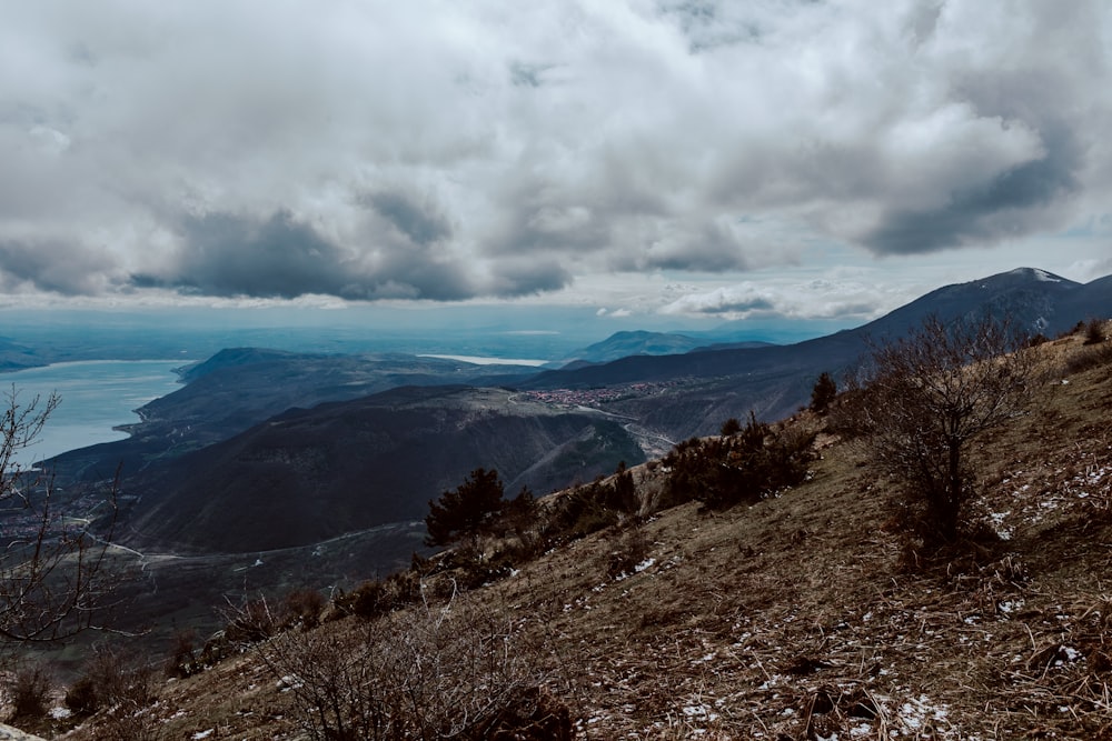 a view of a mountain with a body of water in the distance