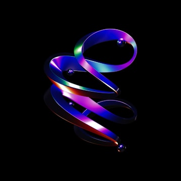 A digital artwork featuring a swirling, ribbon-like structure with a gradient of vibrant colors including blue, purple, green, and red. Reflective spheres are embedded along the structure, all set against a stark black background that enhances the dramatic contrast and luminescence of the design.