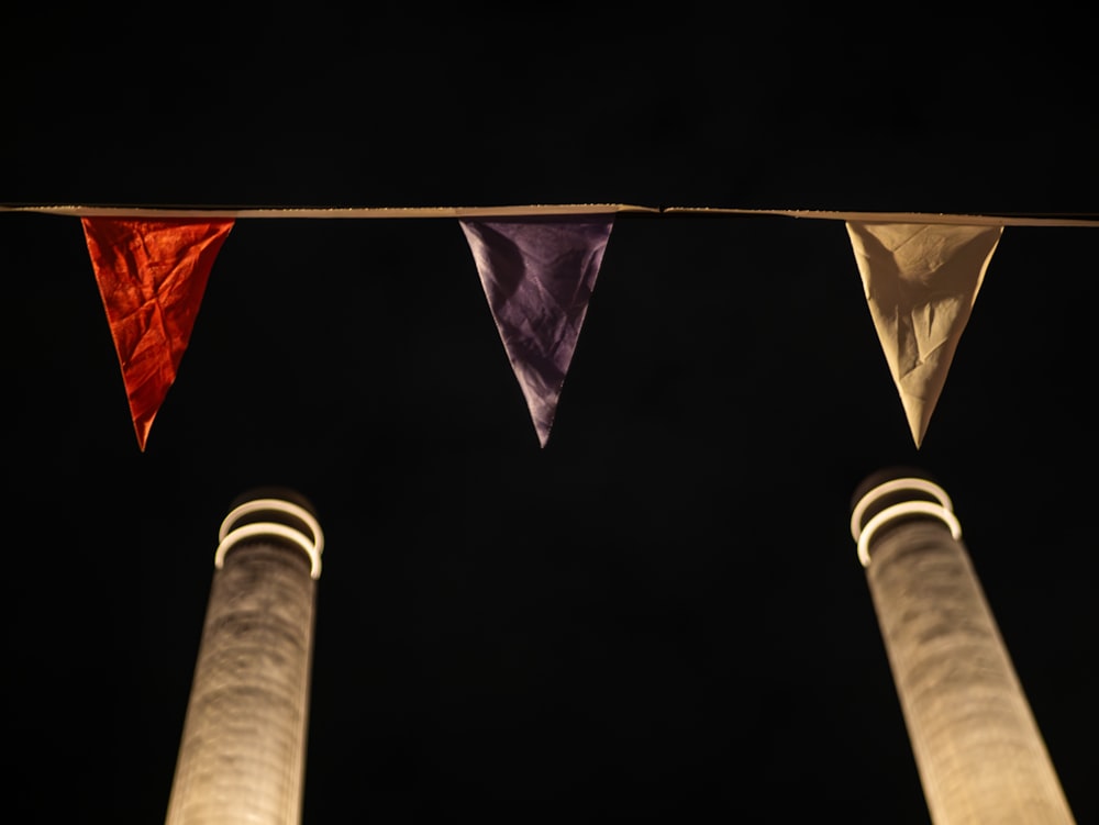a group of three flags hanging from a line
