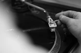 Close-up of hands carefully placing a classic record on a turntable.