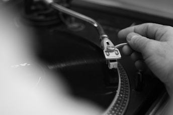 a person is fixing a record player on a turntable