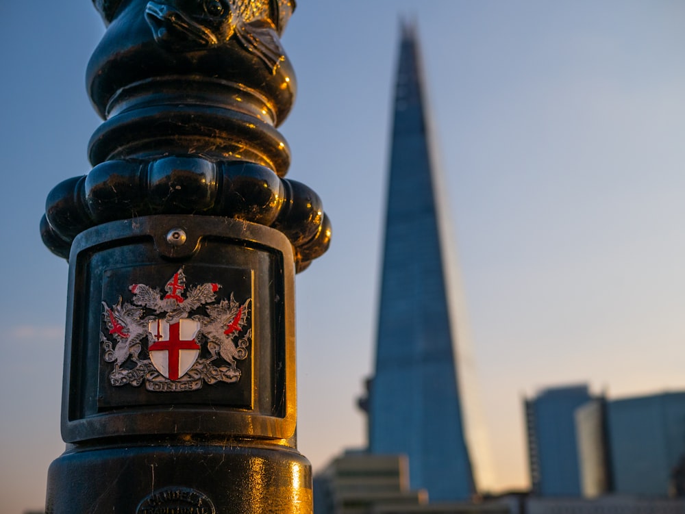 a close up of a pole with a building in the background