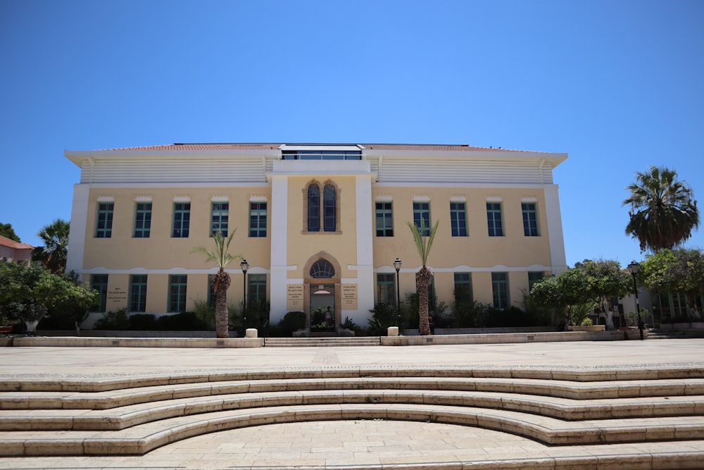 a large yellow building with steps leading up to it