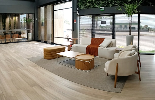 Modern minimalist living room with wooden furniture and large windows, showcasing elegant home design.