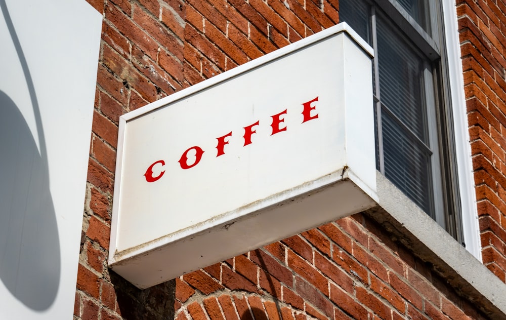 a close up of a sign on a brick building