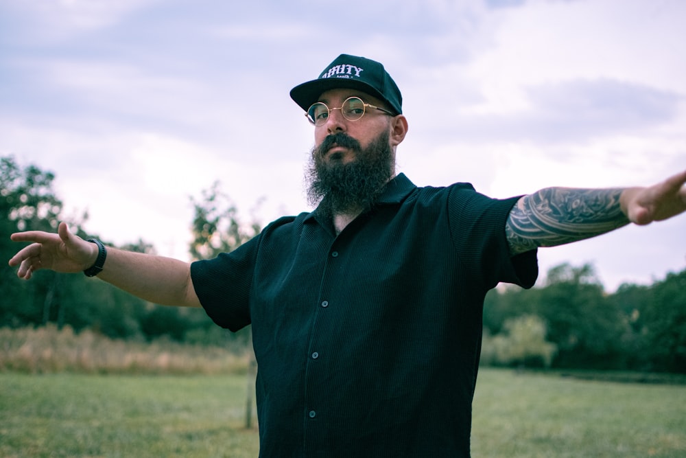 a man with a beard wearing a hat and glasses