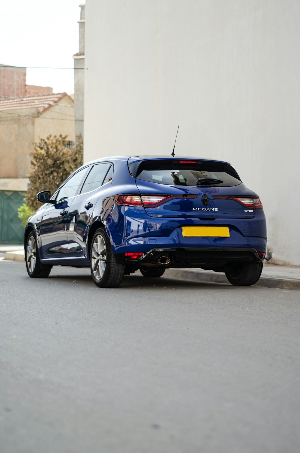 a blue car parked on the side of the road