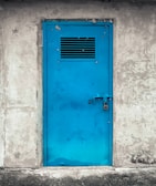 A large industrial steel door with secure locking mechanisms.
