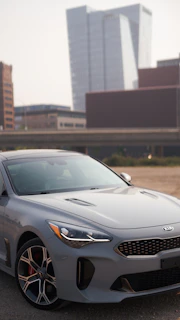 A Kia Sonet gleaming under city lights, ready for a one-way trip.