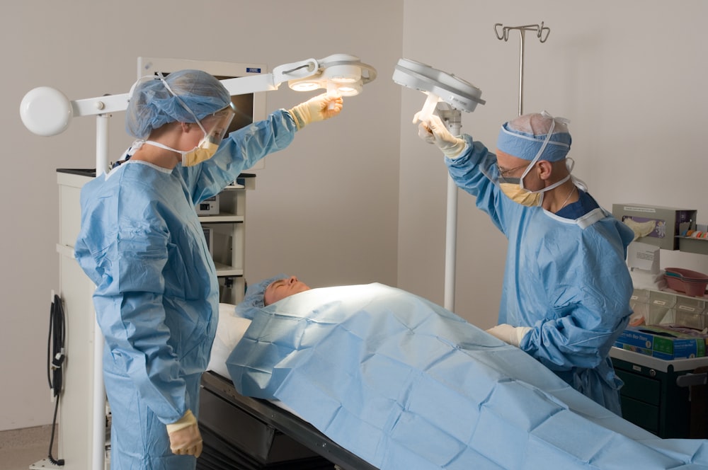 two doctors performing surgery on a patient in a hospital