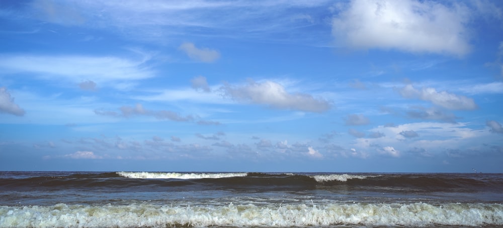 a person riding a surfboard on top of a wave