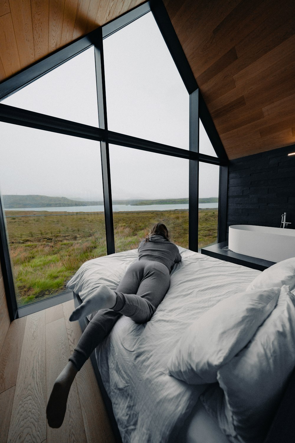 a person laying on a bed in a room