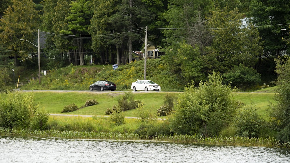 a couple of cars that are sitting in the grass