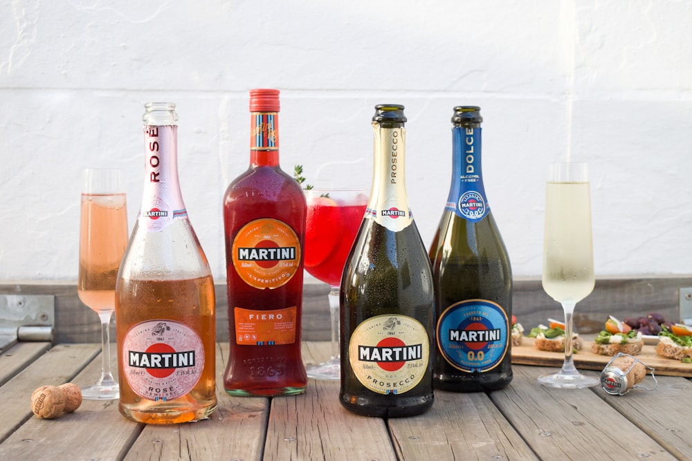 a group of bottles of wine sitting on top of a wooden table