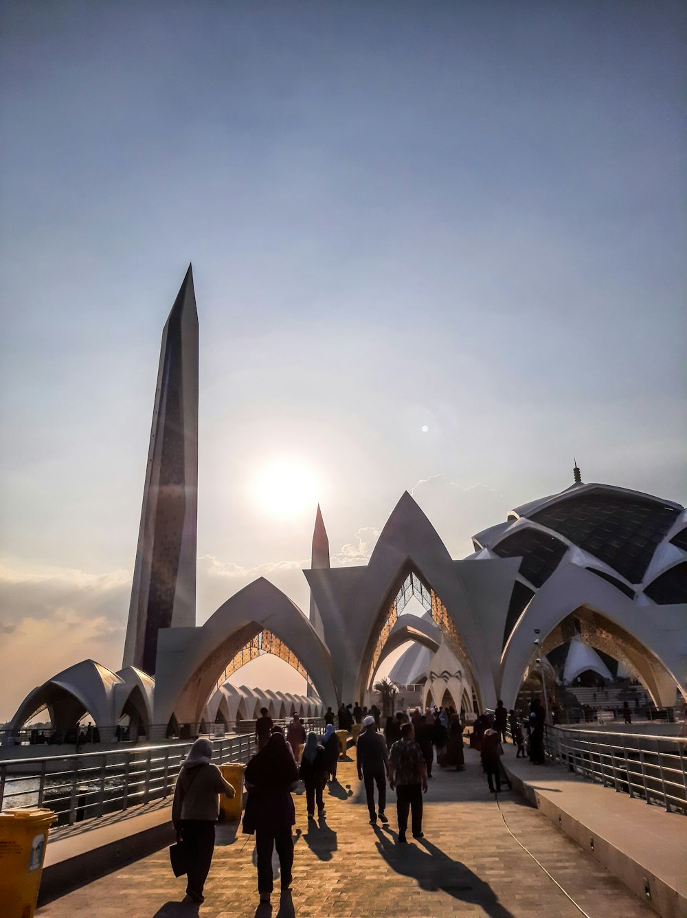 a group of people walking across a bridge