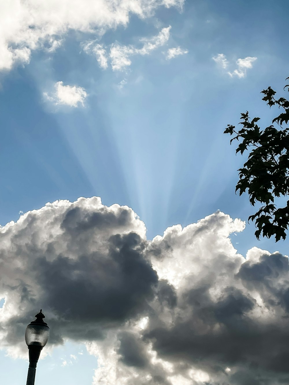 a street light in front of a cloudy sky