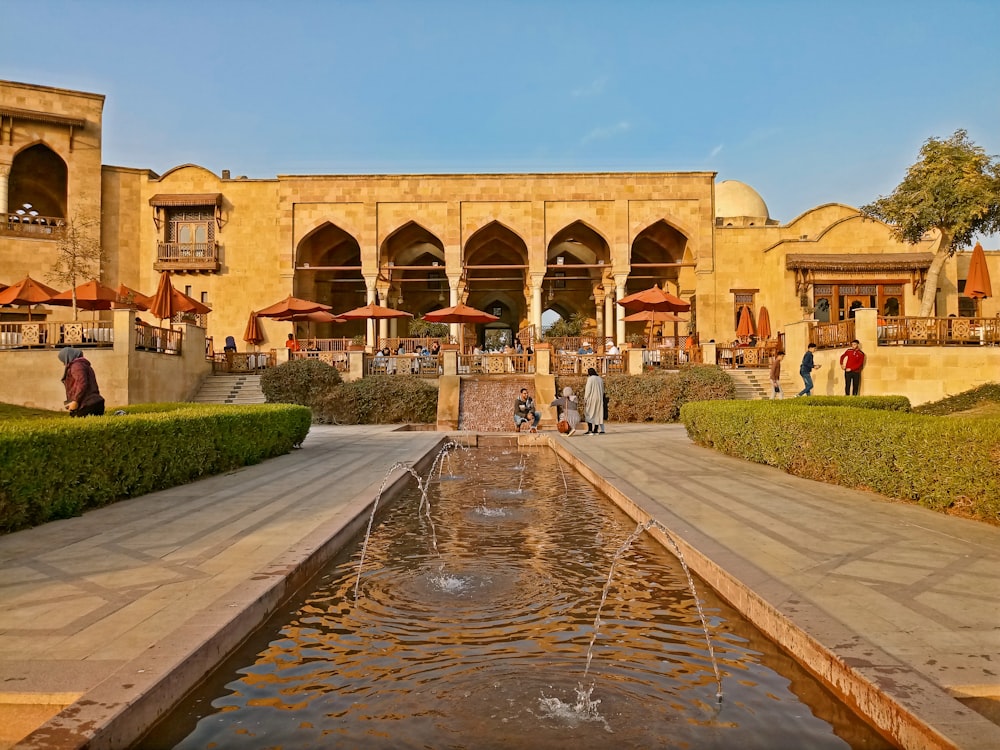 a large building with a fountain in front of it