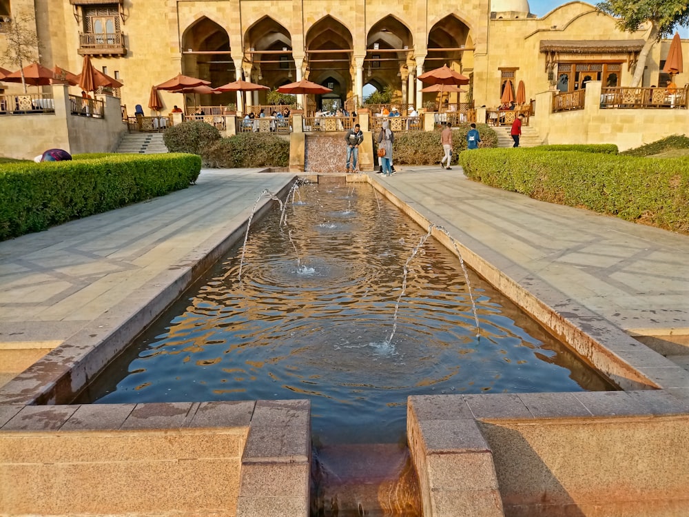 a large building with a fountain in front of it