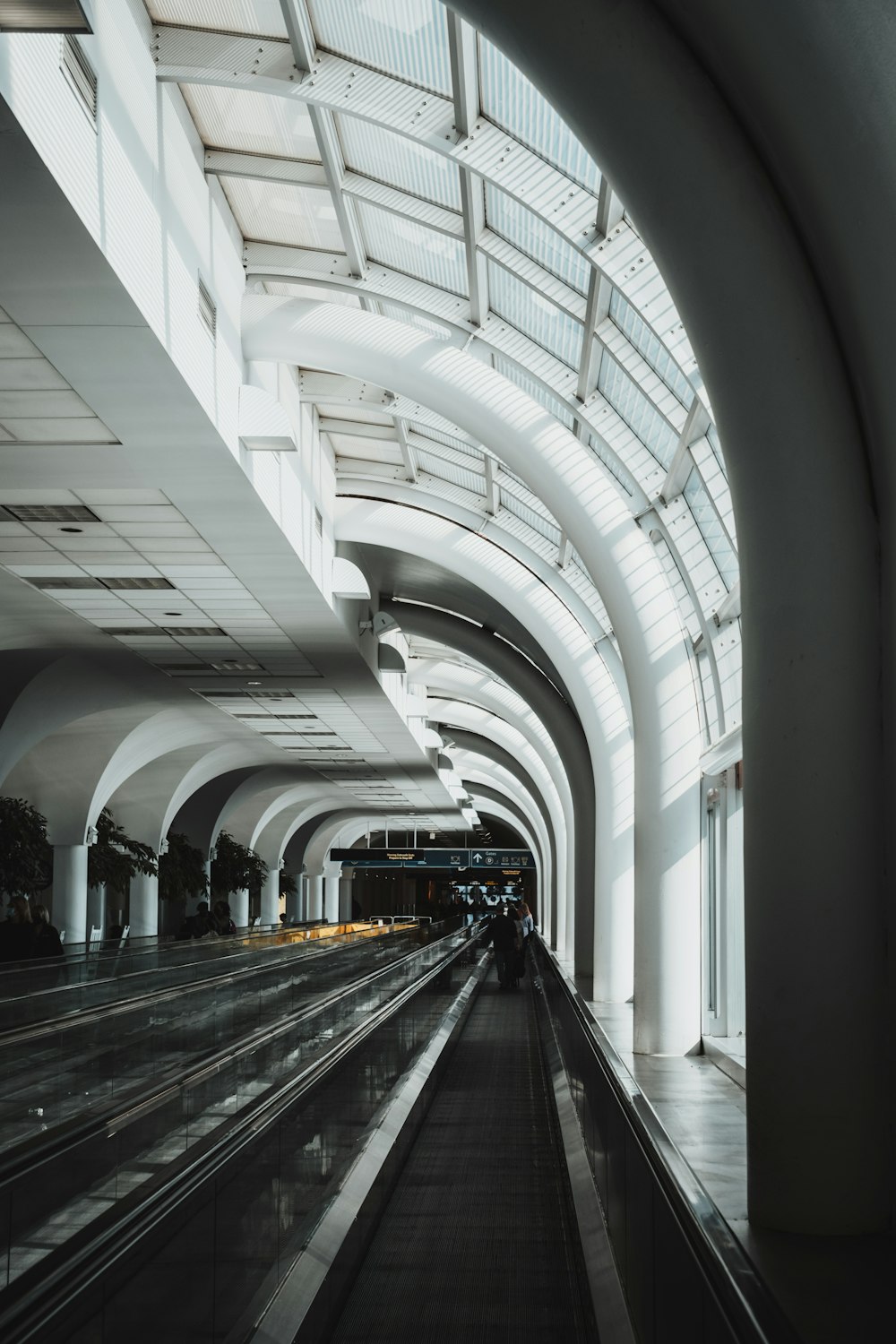 a train traveling through a train station next to a tall building