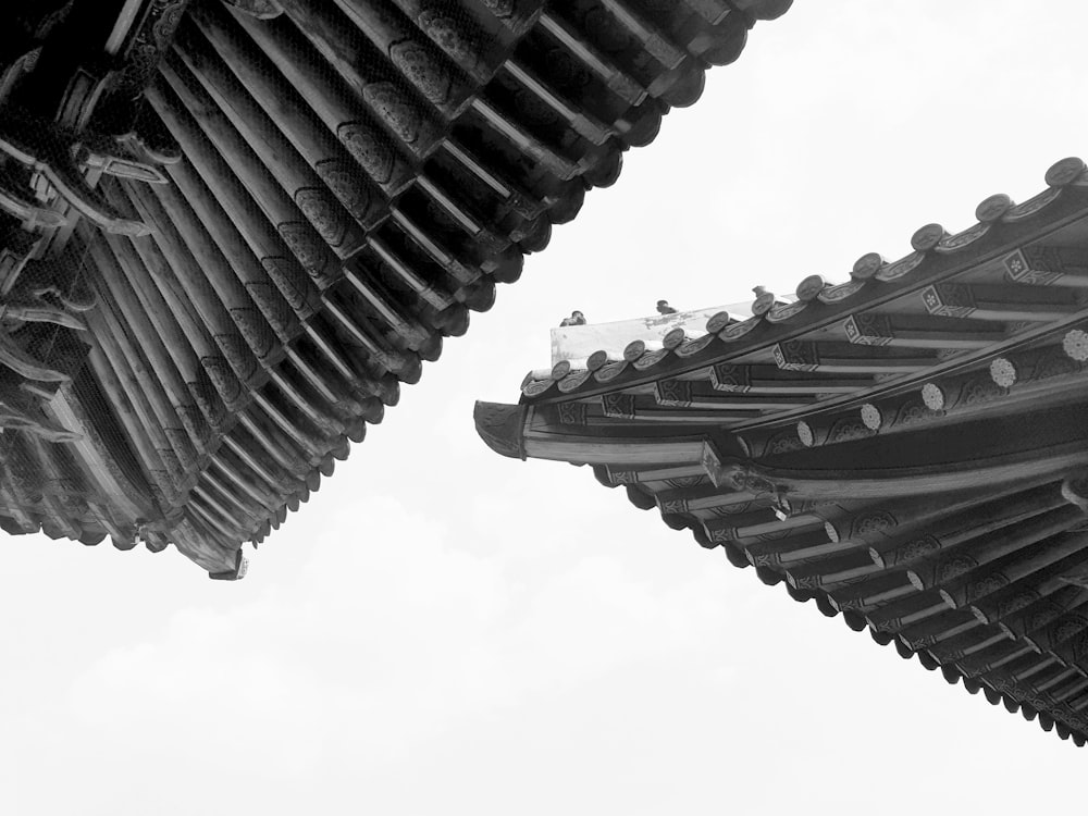 a black and white photo of a pagoda roof