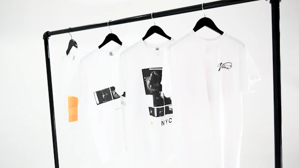 Vibrant t-shirts with bold, colorful graphic designs displayed on a clean white background.