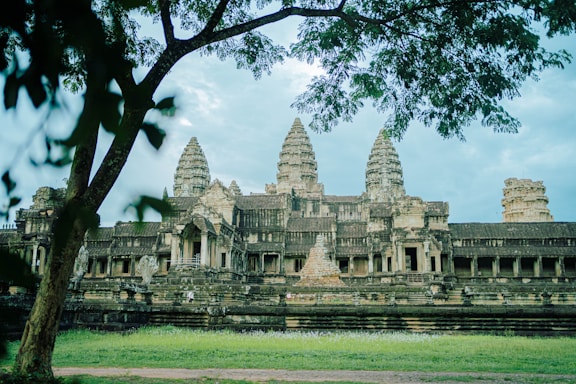 a large stone building with a tree in front of it