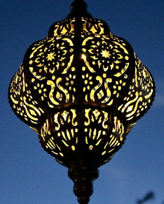 A beautifully crafted lamp inspired by world religions, glowing warmly in a cozy room.