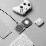 Assorted tech accessories including earbuds and chargers arranged neatly on light gray fabric